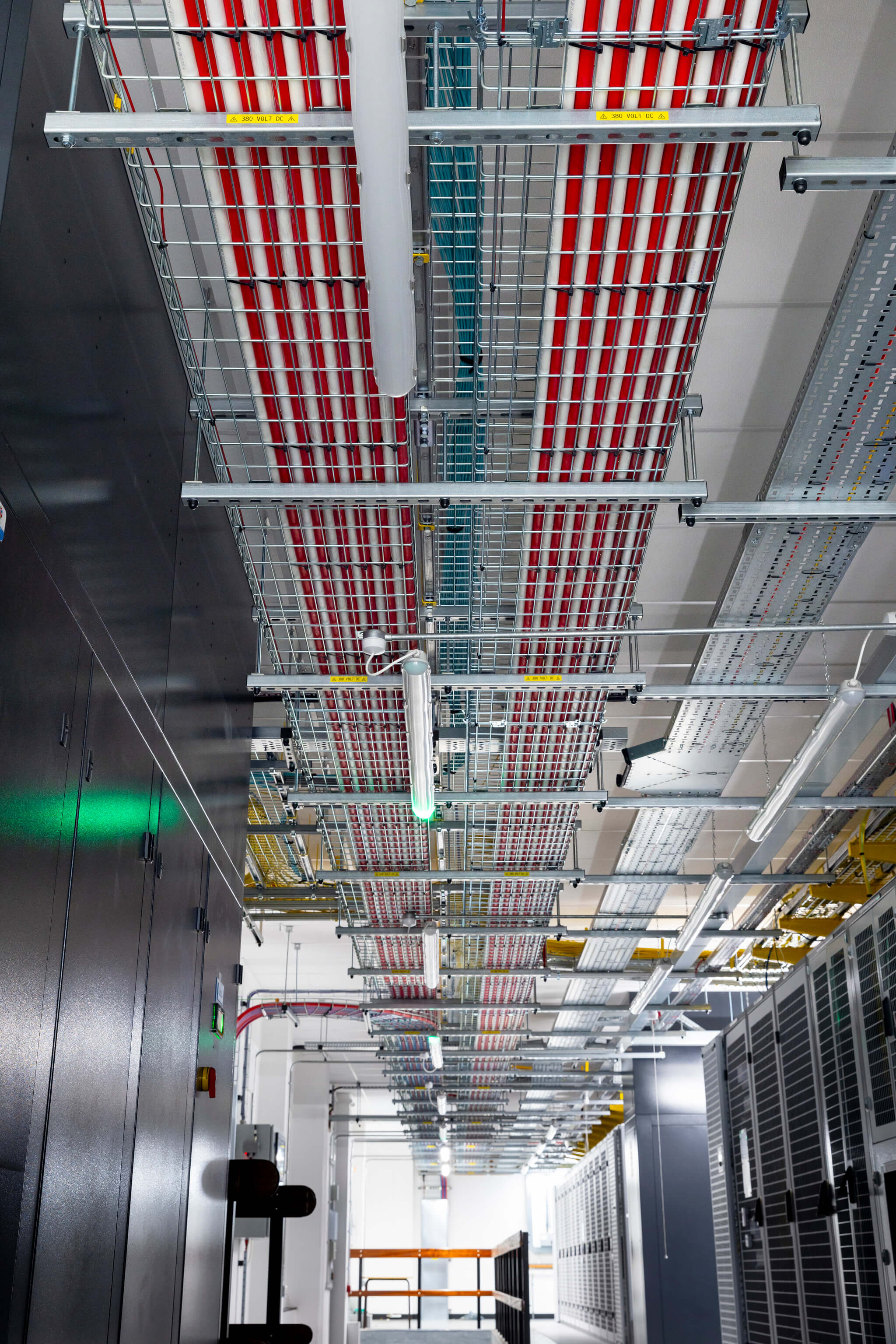 View of completed cabling that has been installed on the ceiling of a data centre facility. 