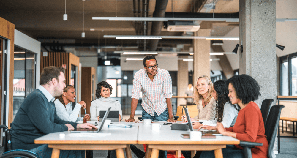 Group of colleagues working at a conference table discussing a project.