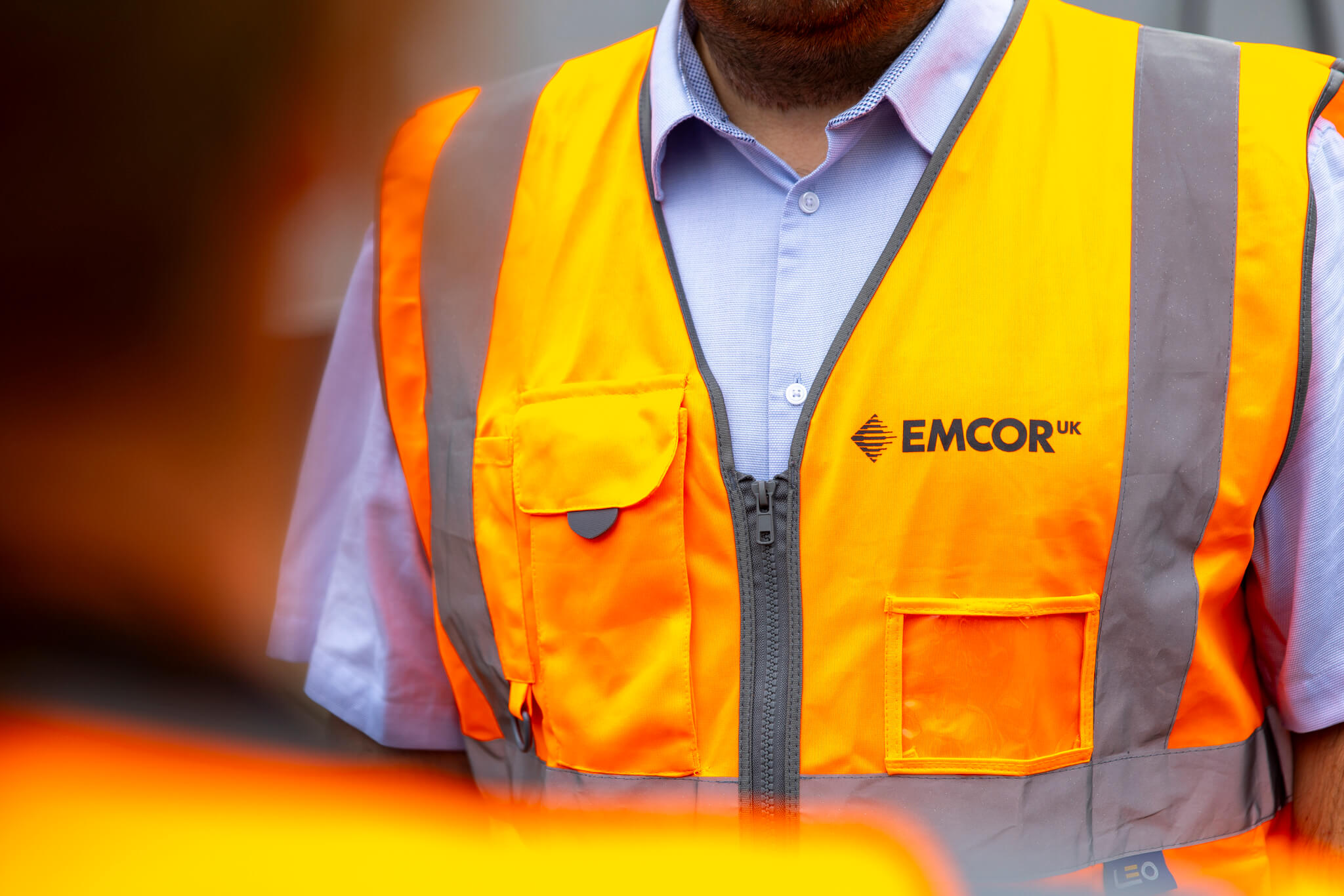 Close up of a man wearing hi-vis jacket. 