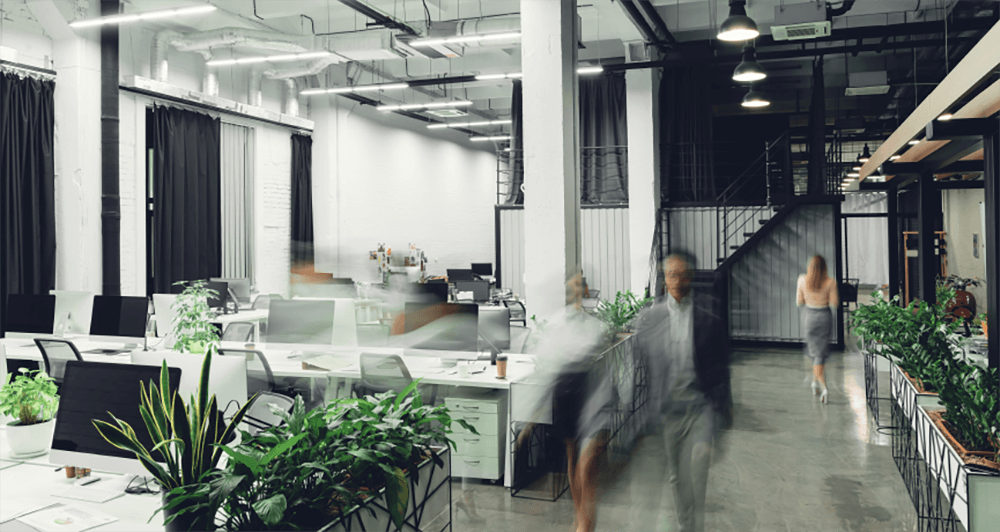 Two people walking in a corporate office setting